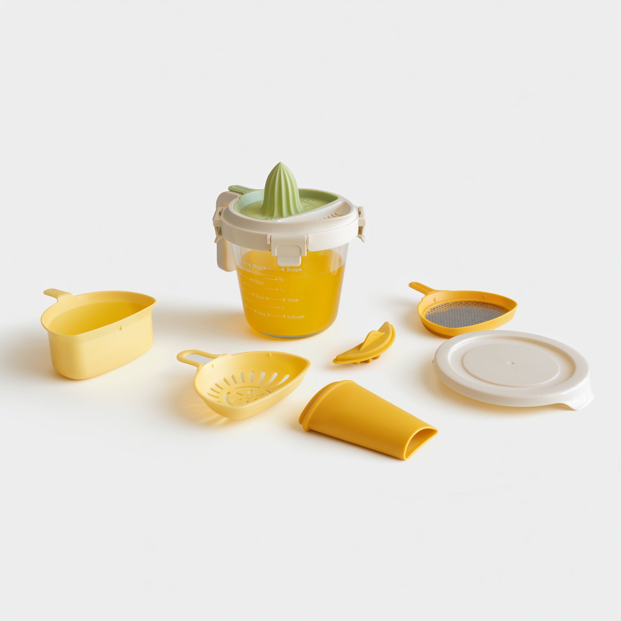 Set of yellow kitchen tools including a juicer, strainer, and scoop on a white background